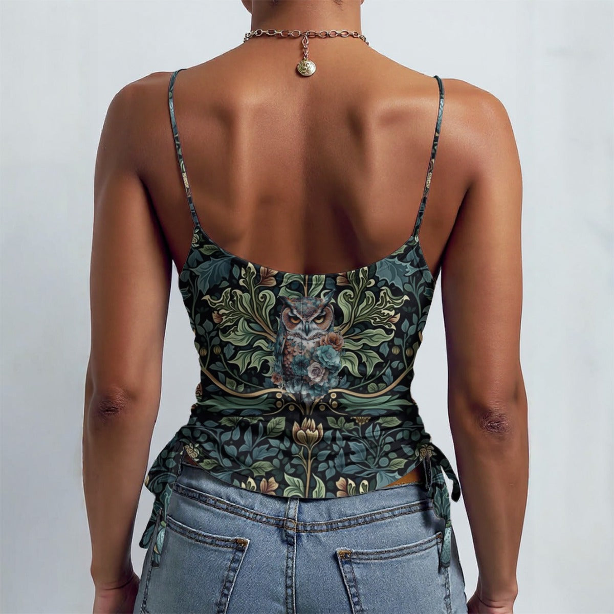 Person wearing a floral corset top and jeans on a plain background