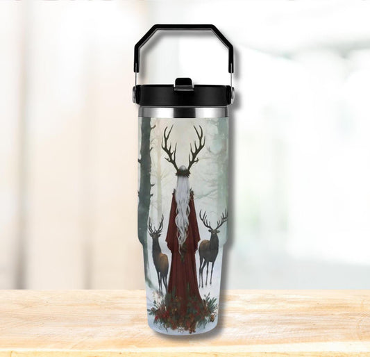 Tumbler with deer design on a wooden surface