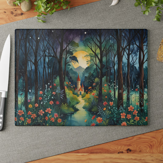 Decorative cutting board with a forest and castle design on a gray surface.
