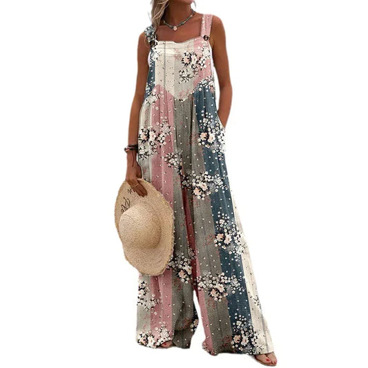 Woman wearing a floral jumpsuit holding a straw hat on a white background