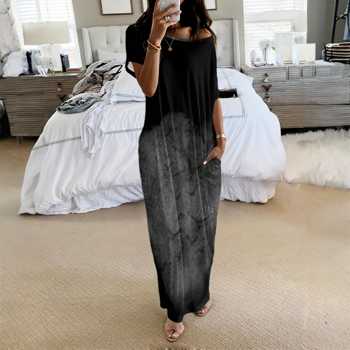 Woman wearing a black and gray gradient dress in a bedroom setting.