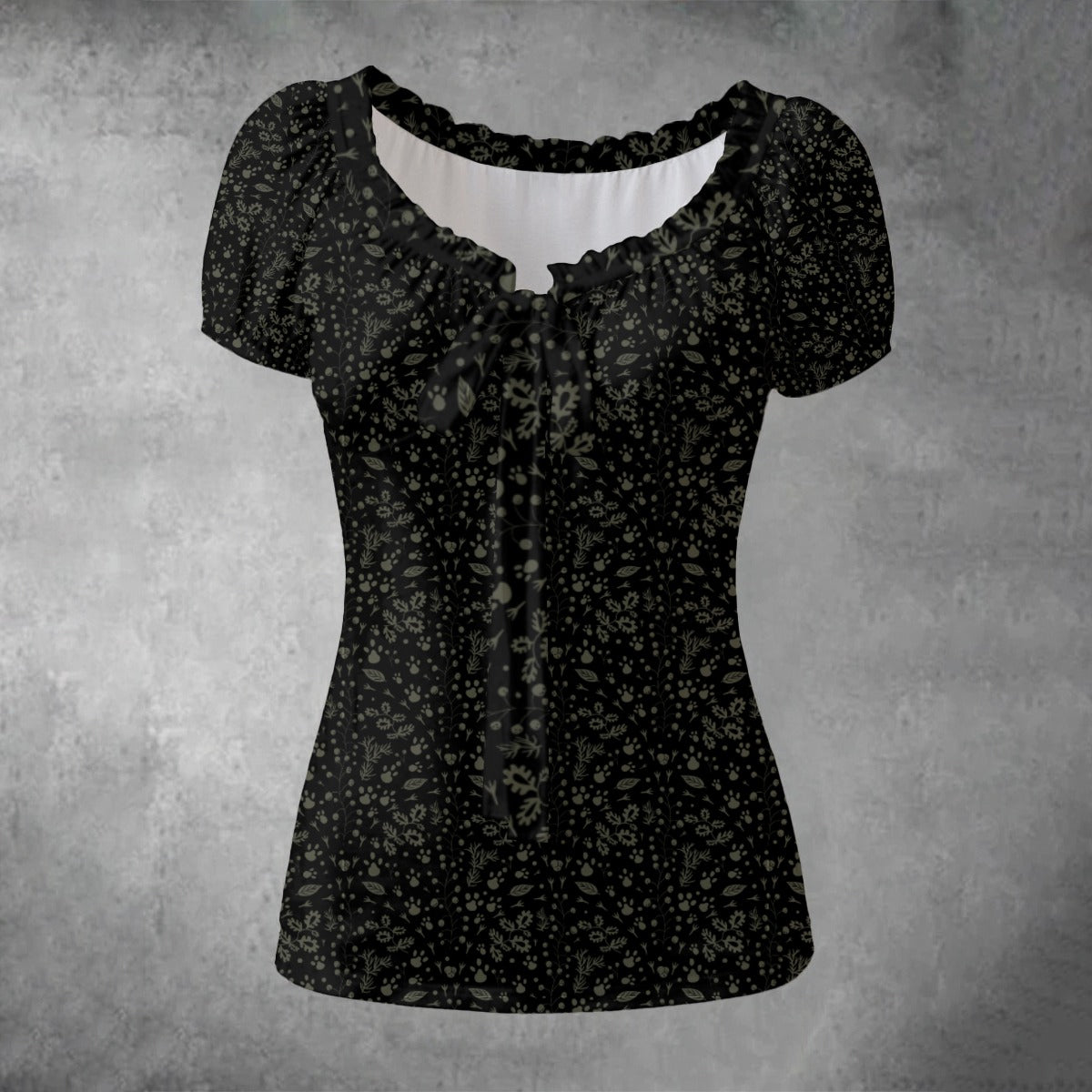 Black floral-patterned blouse on a textured gray background