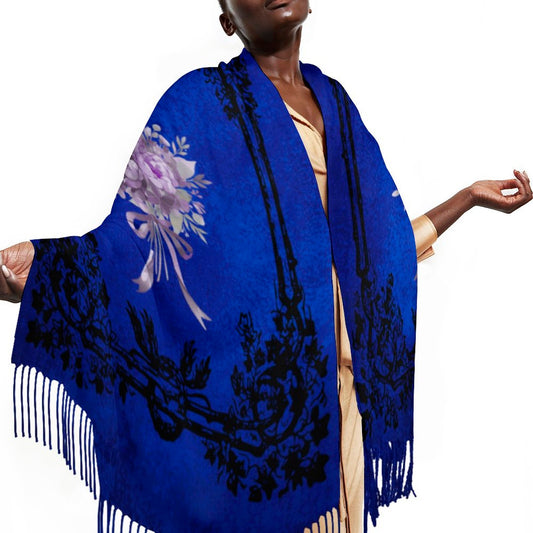 Blue floral-patterned shawl with black designs and white fringes on a model against a white background