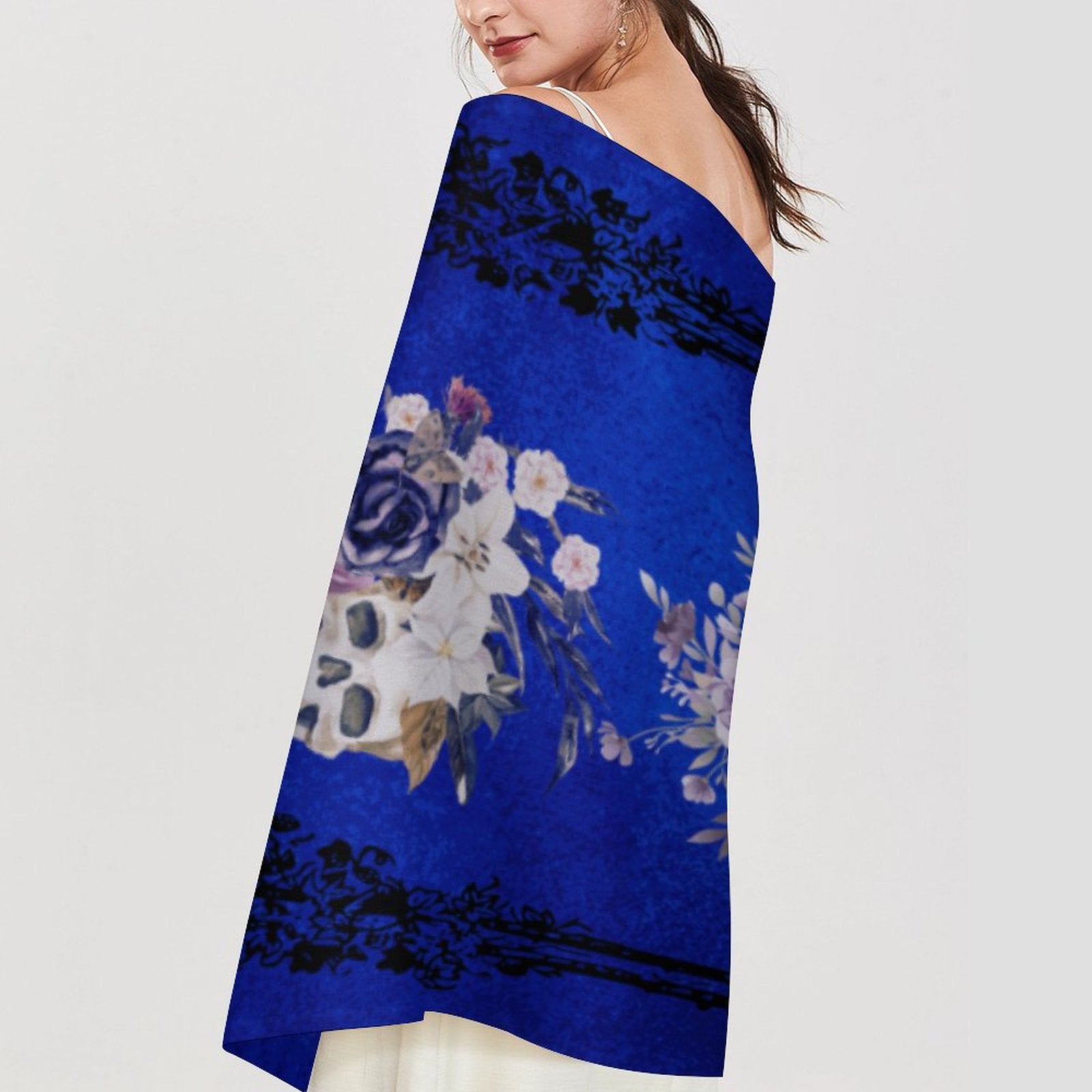 Woman wearing a blue floral dress with a white background