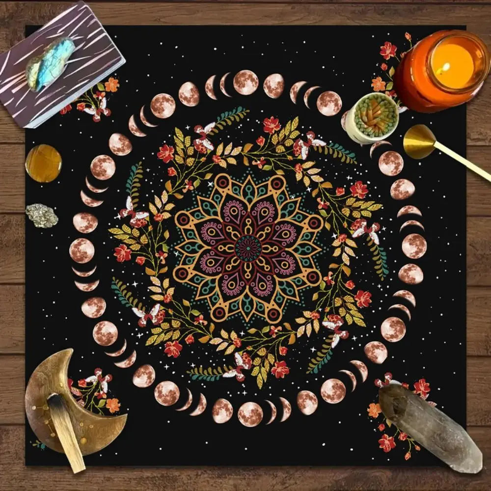 Decorative mat with mandala design, moon phases, and mystical items on a wooden surface.