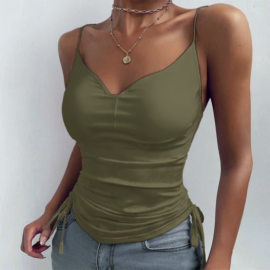 Green tank top worn by a person on a plain background