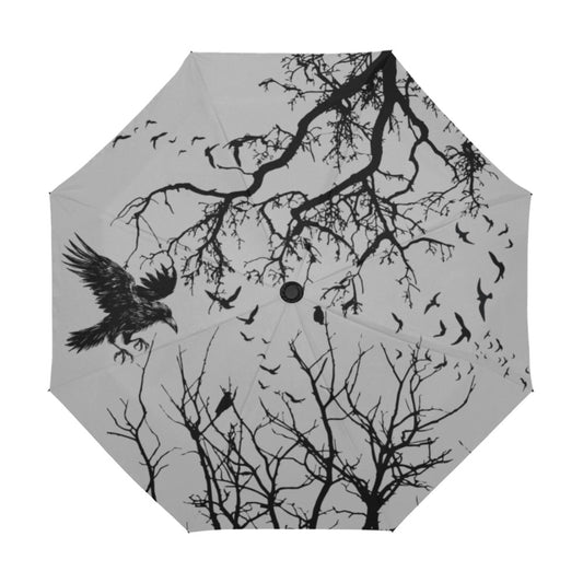 Umbrella with black tree branches and birds design on a gray background