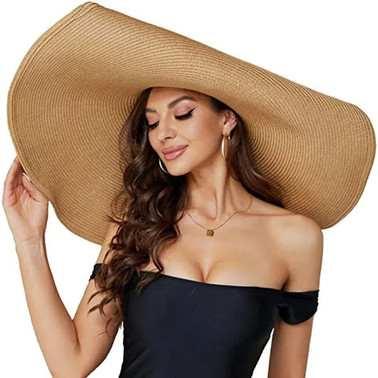 Woman wearing a large straw hat on a white background