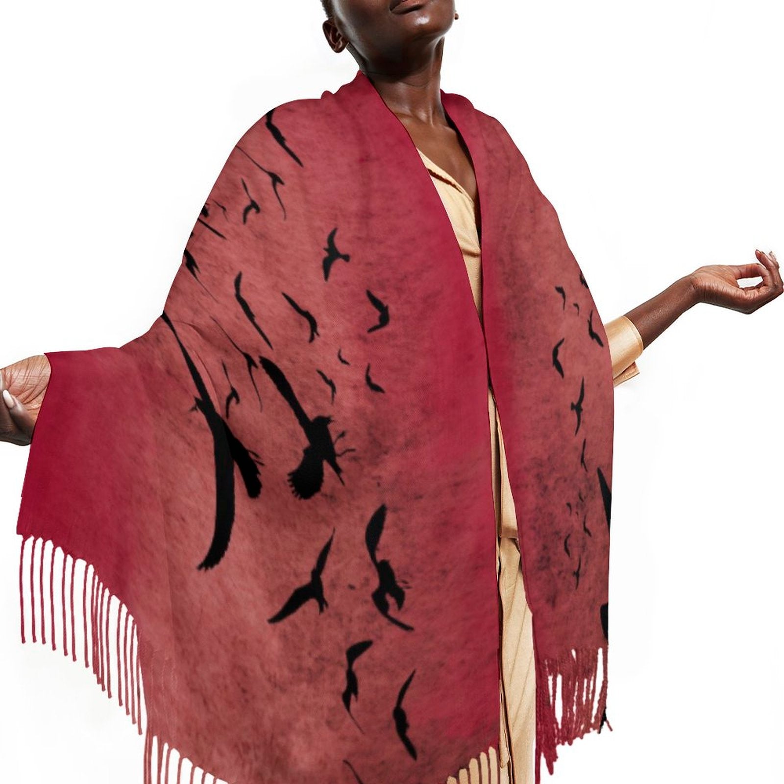 Red scarf with black bird patterns and fringes worn by a model on a white background