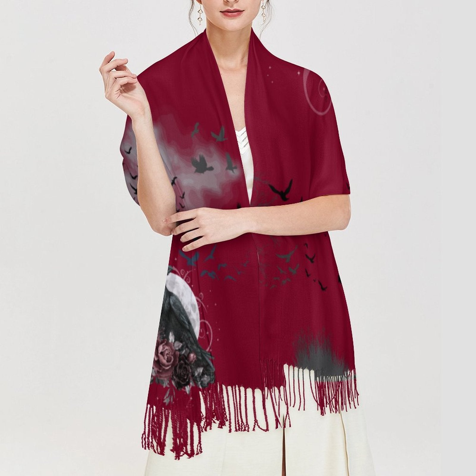 Woman wearing a red scarf with black bird patterns on a white background