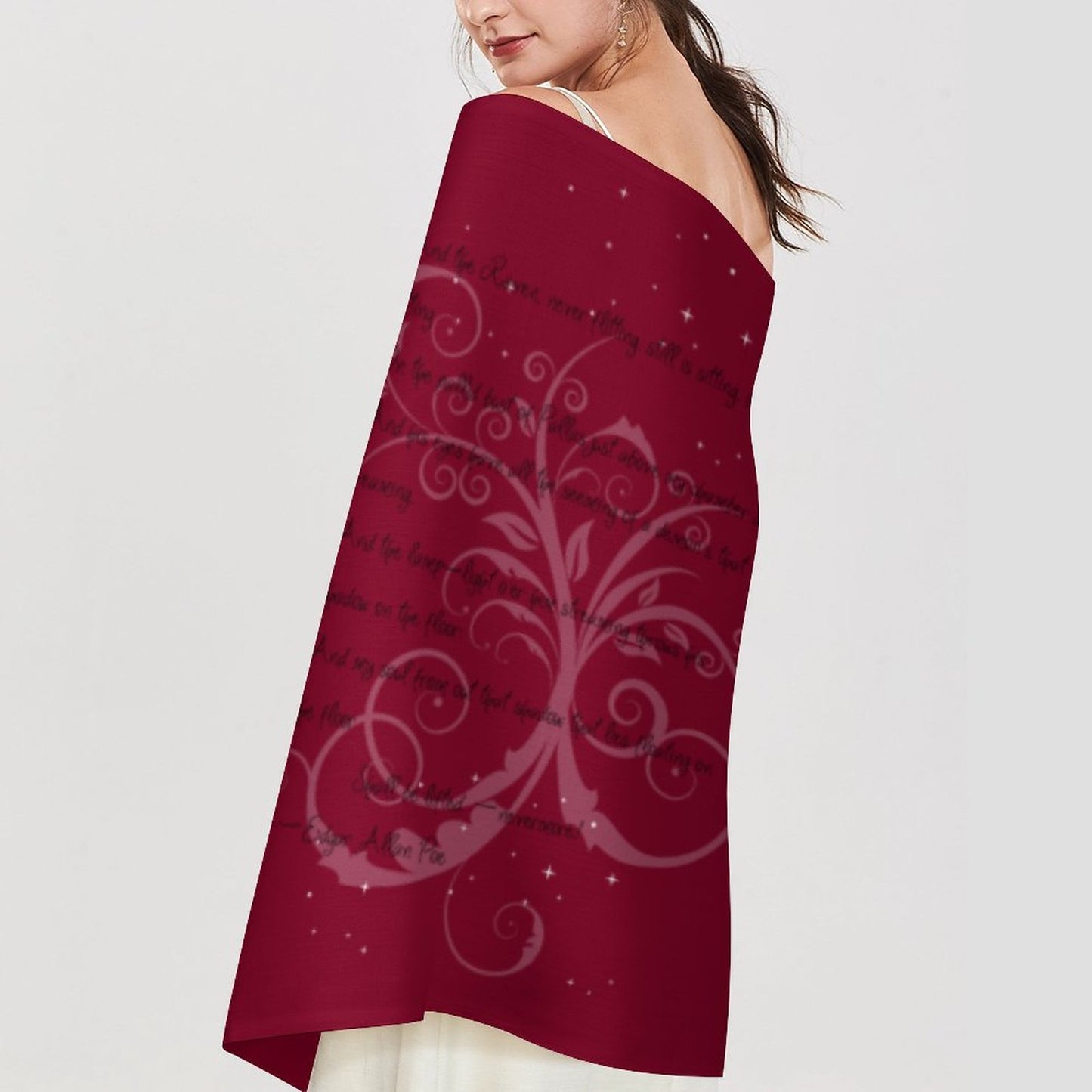 Woman wearing a burgundy scarf with decorative patterns and text on a plain background