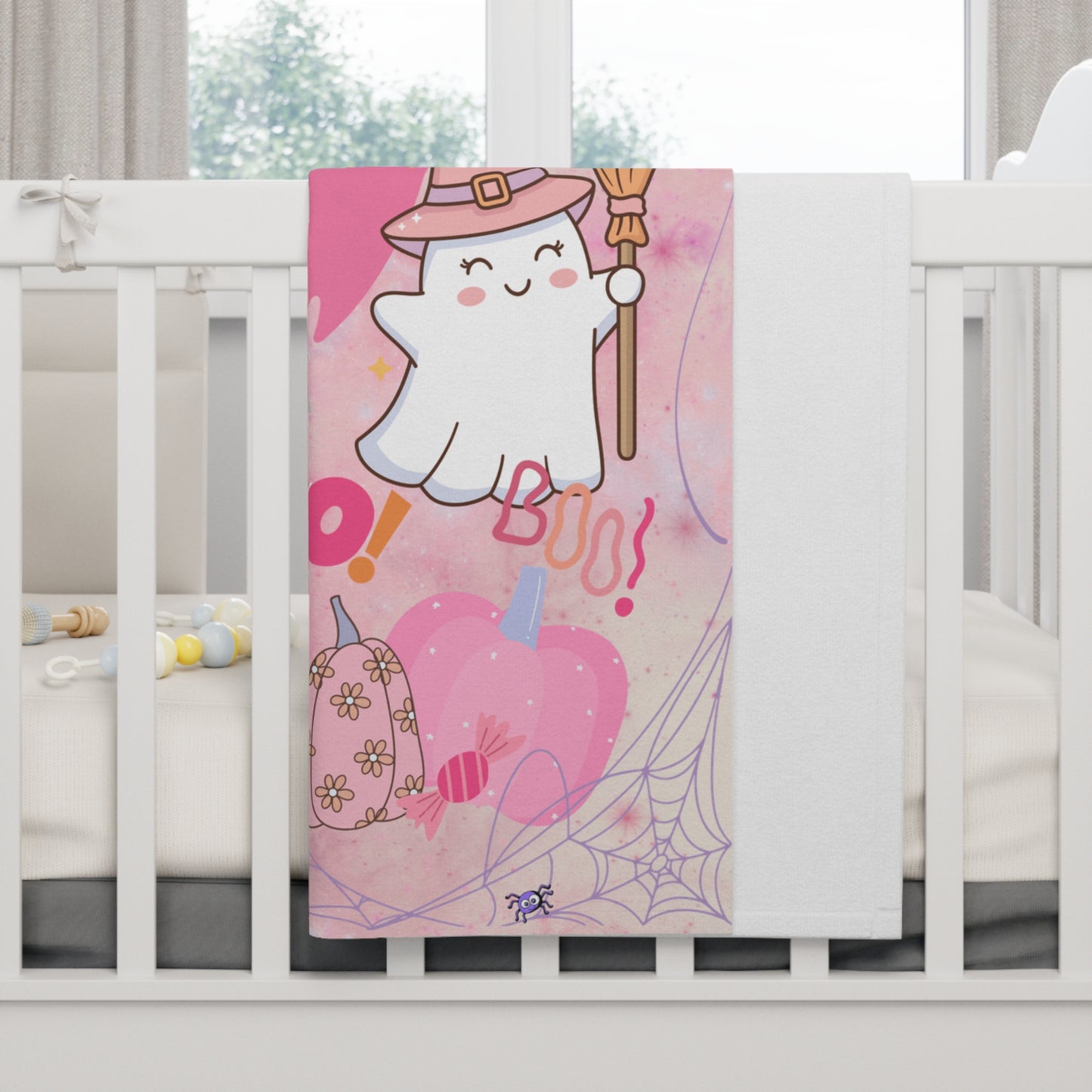 Cute ghost design on a pink background with Halloween elements, hanging over a crib.
