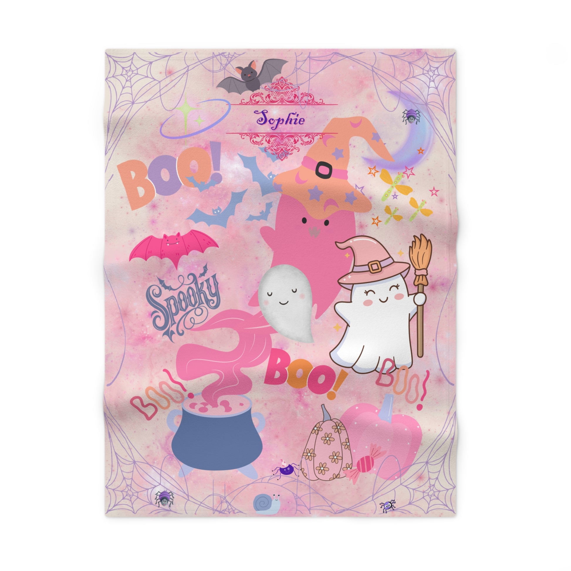Halloween-themed blanket with cartoon ghosts, pumpkins, and text on a pink background