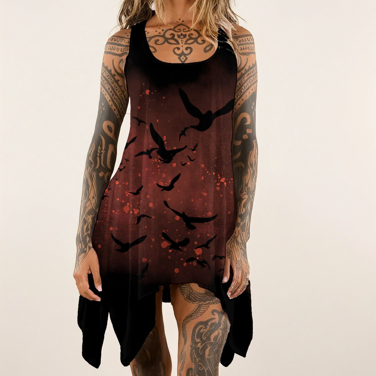 Person wearing a dark dress with bird pattern on a plain background