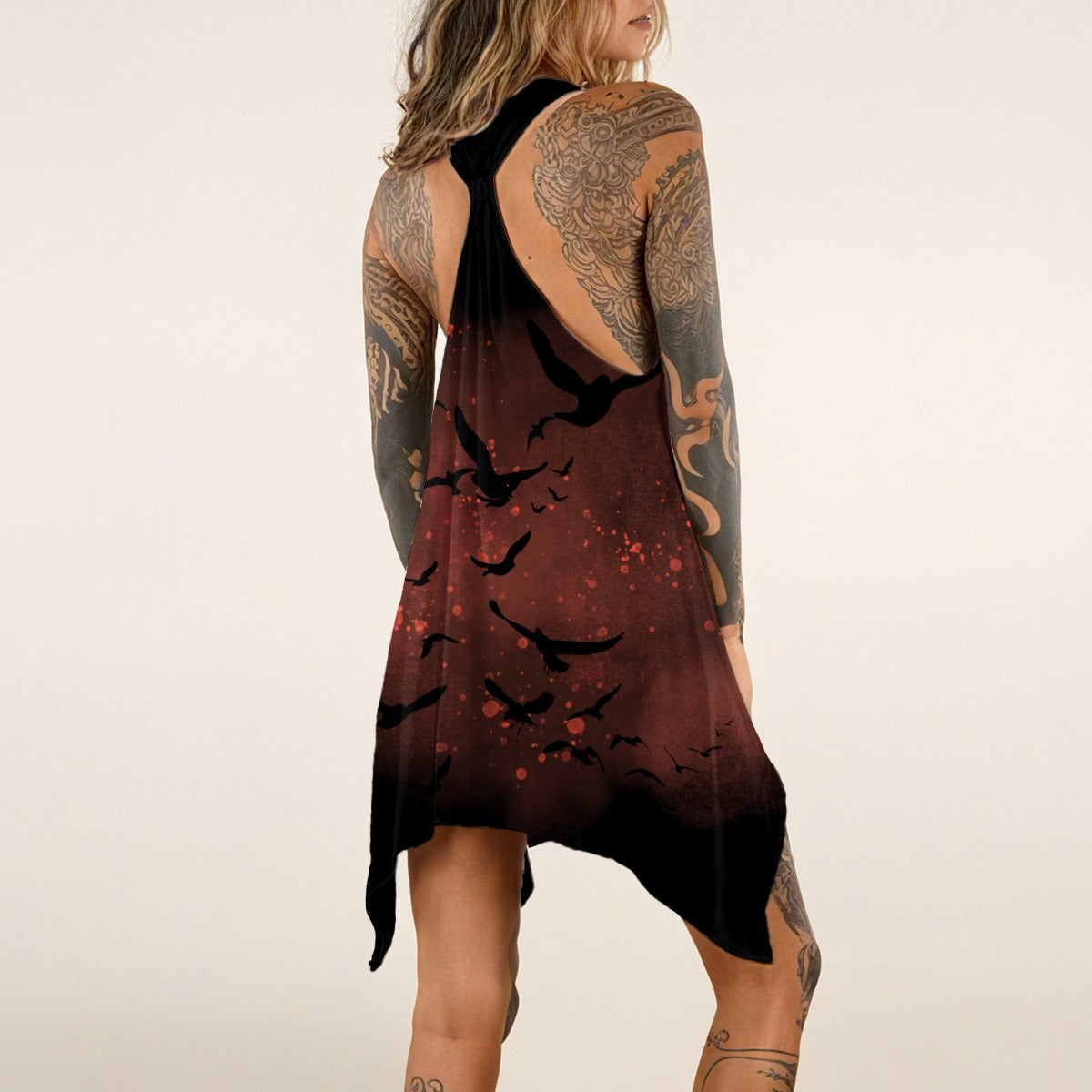 Woman wearing a dress with black bird pattern and open back design.