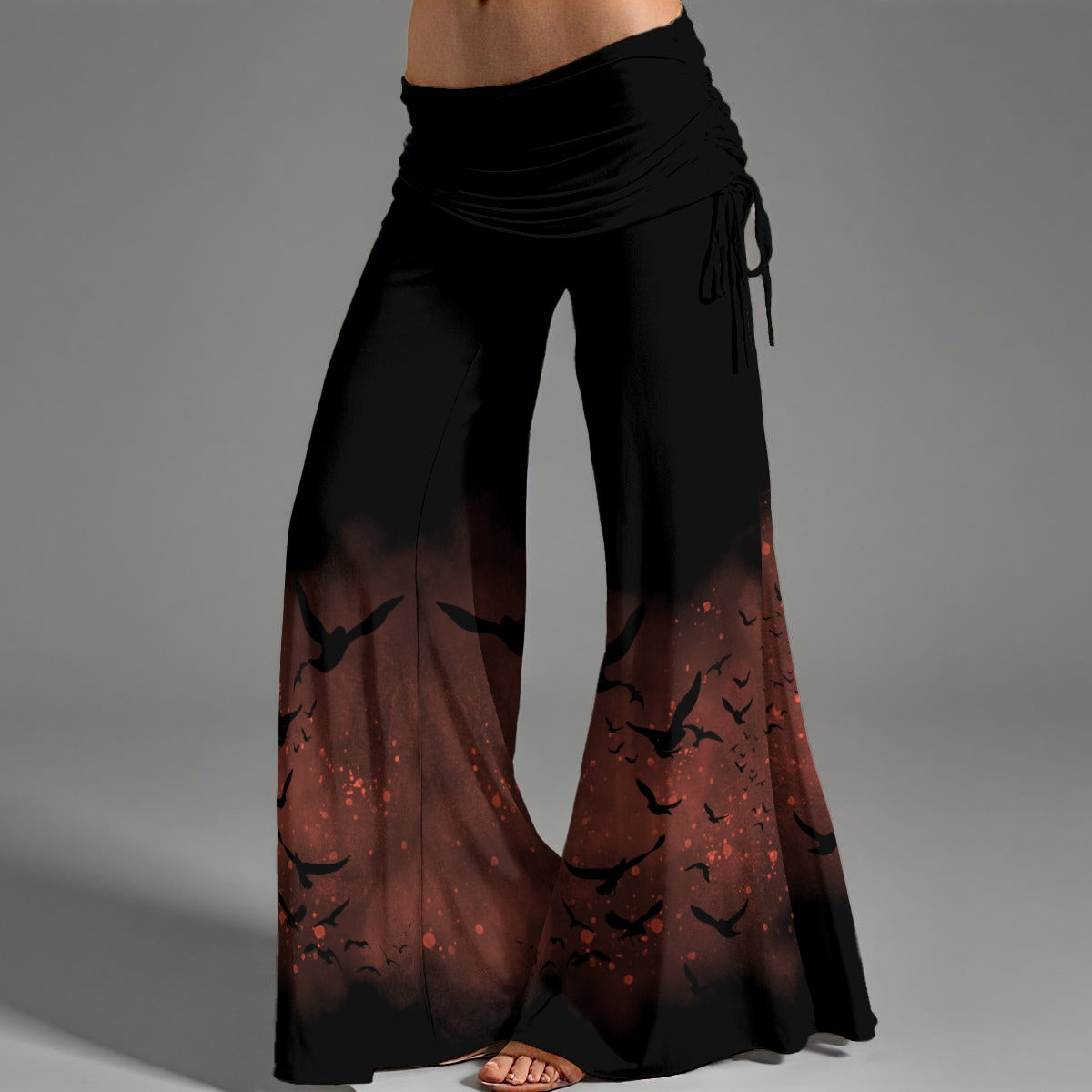 Black and red patterned pants with a gradient effect on a gray background