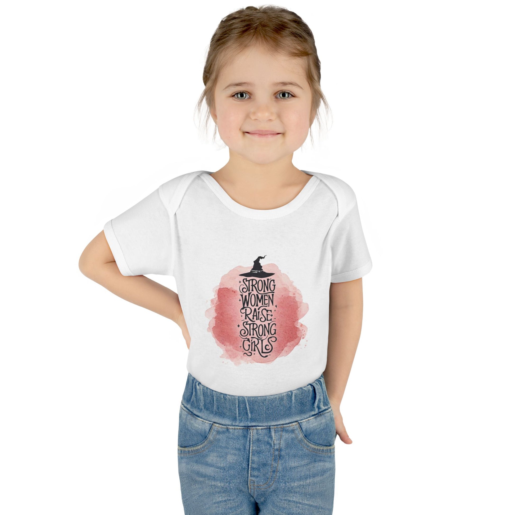 Young girl wearing a white t-shirt with a graphic design and text.