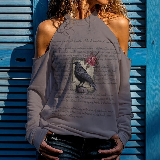 Woman wearing a gray sweatshirt with a graphic design against a blue wooden background