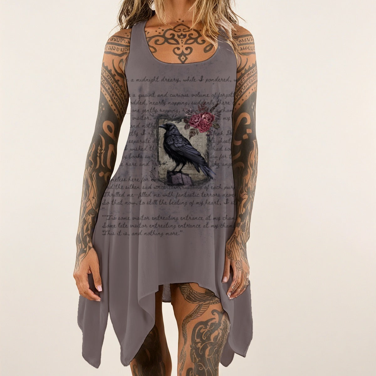 Person wearing a gray sleeveless dress with a graphic design on a plain background