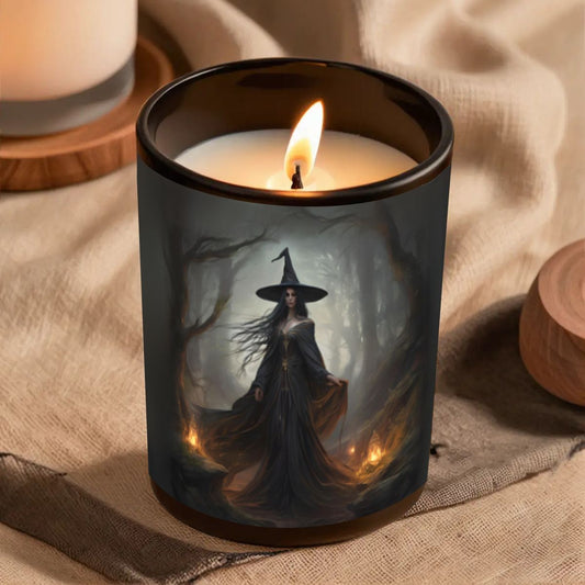 Candle in a jar with a witch design on a textured surface