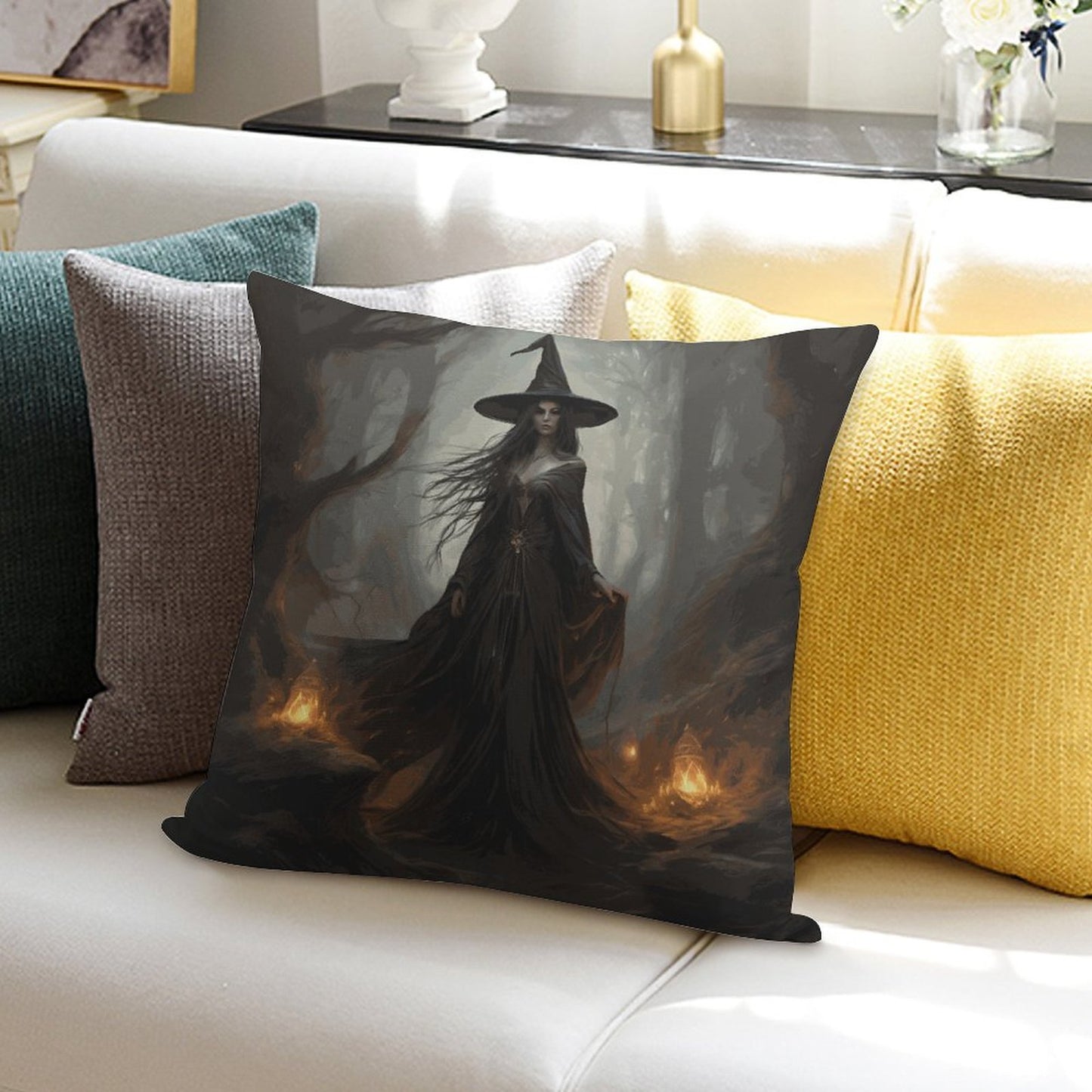 Decorative pillow with a witch design on a couch