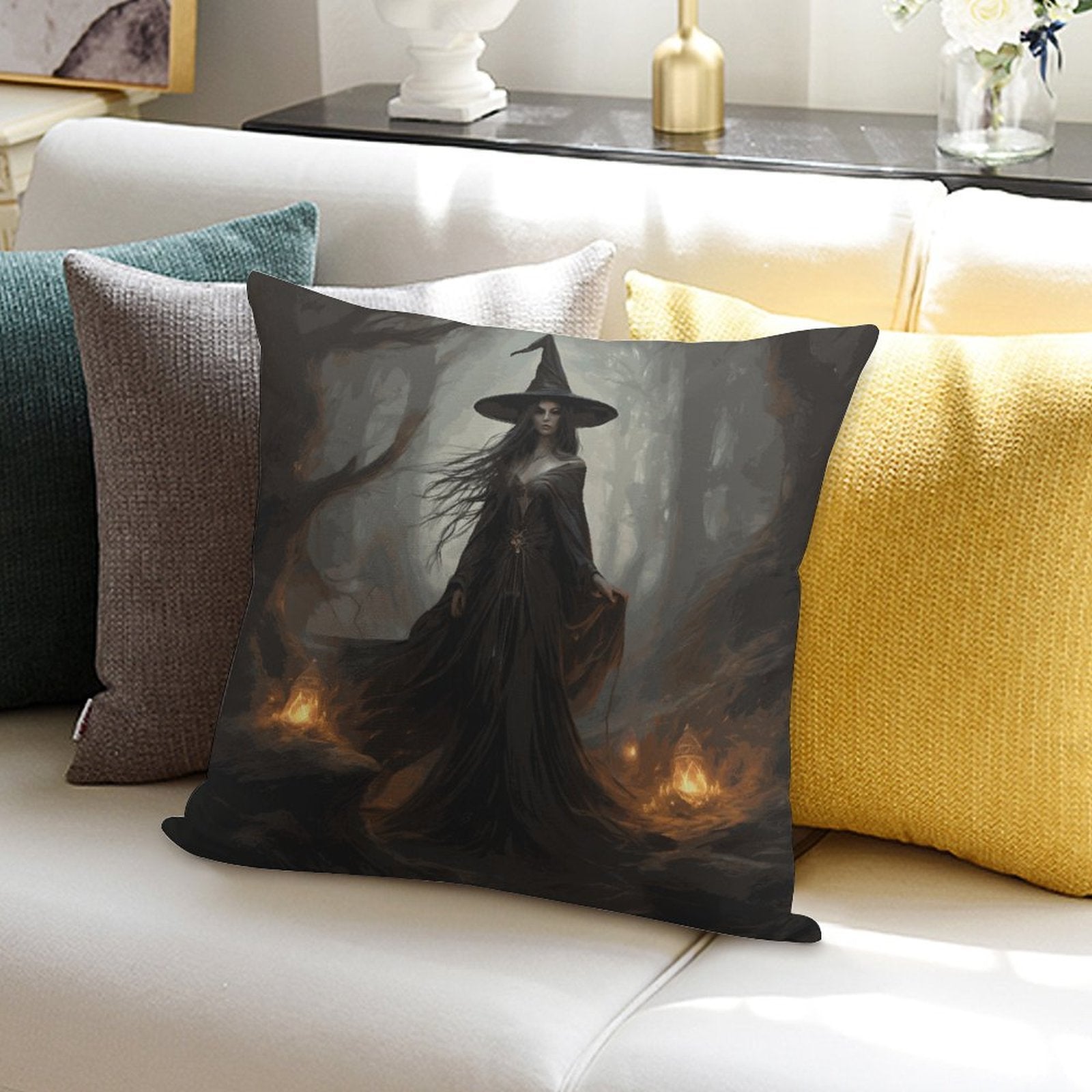 Decorative pillow with a witch design on a couch