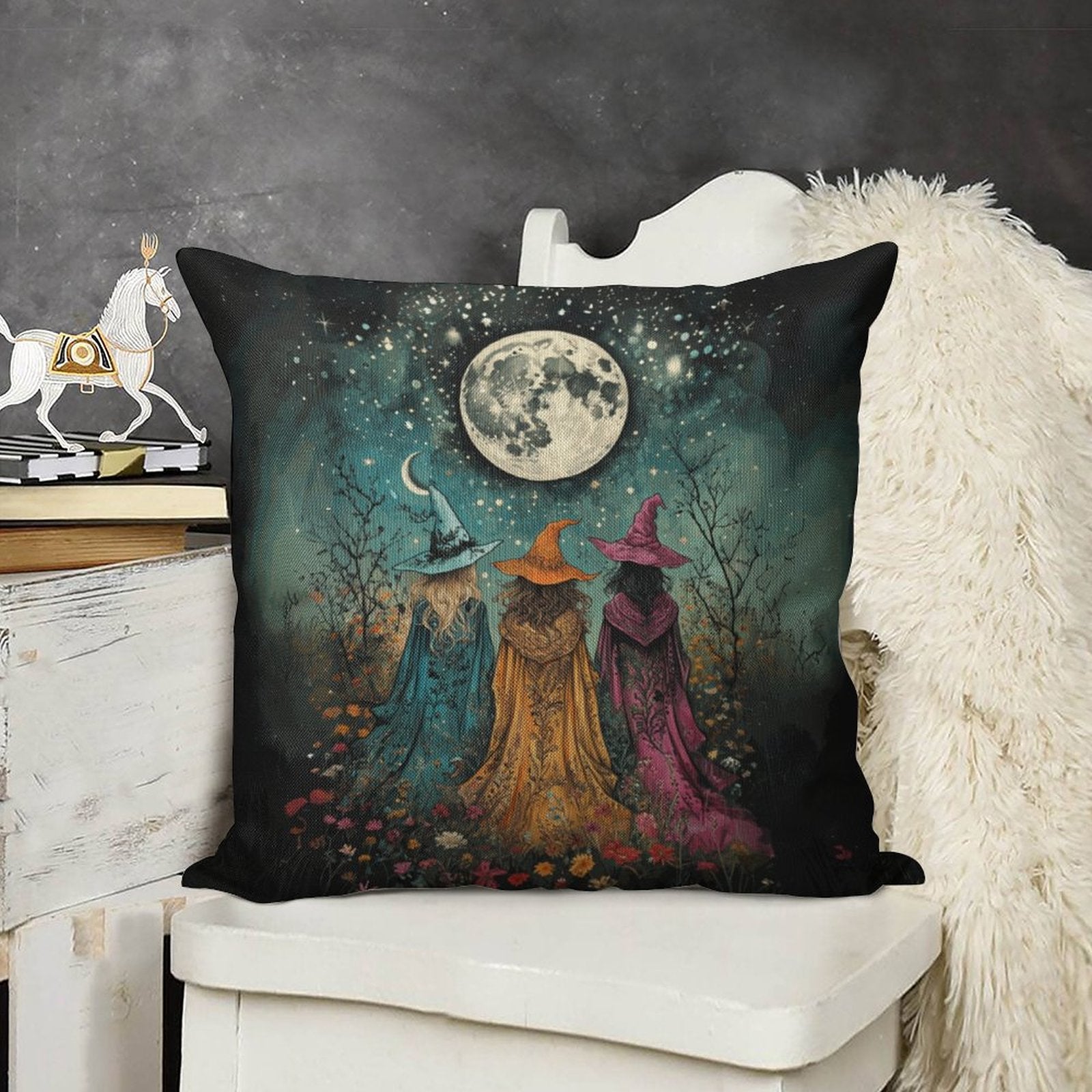 Decorative pillow with witch design on a white surface