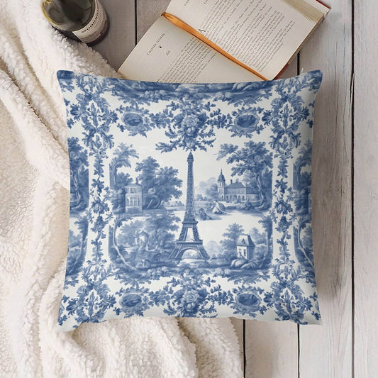 Decorative pillow with blue floral and Eiffel Tower pattern on a white surface