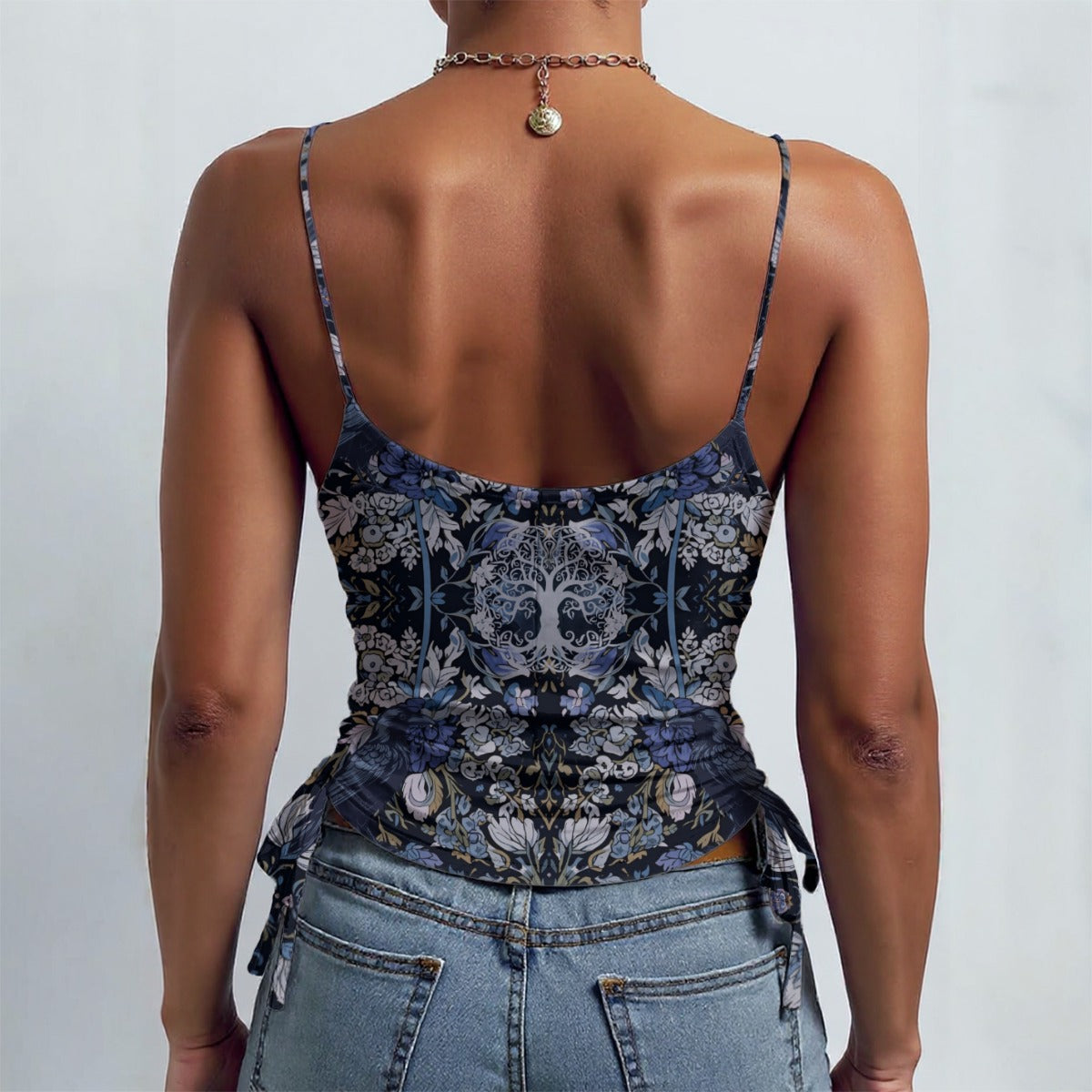 Person wearing a floral top and jeans with a plain background