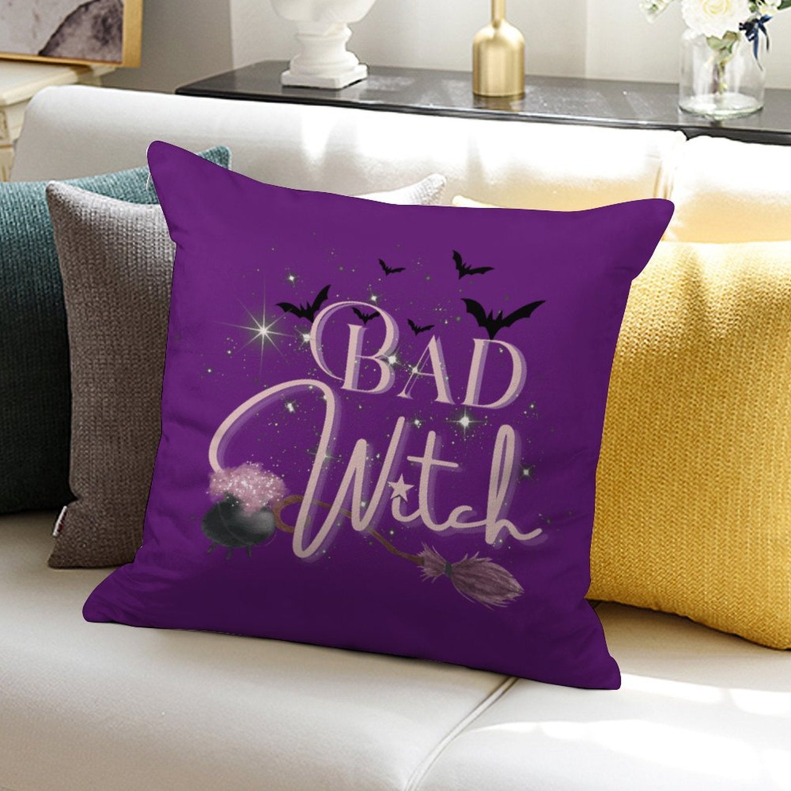 Purple pillow with 'Bad Witch' text on a couch