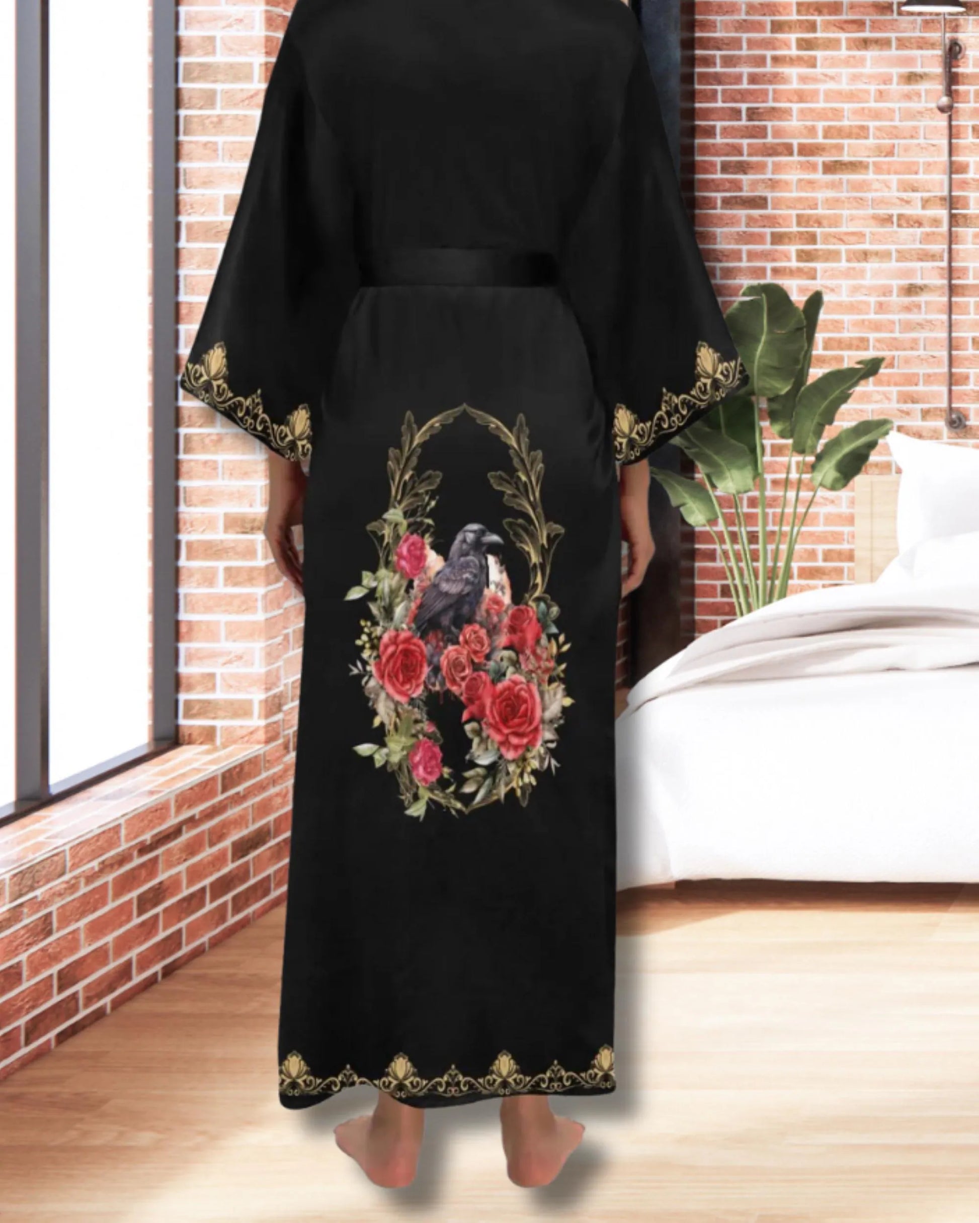 Black dress with floral and bird design in a room with a brick wall and bed.