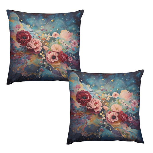Two square plush pillow cases with a floral design in shades of pink and red on a dark background.