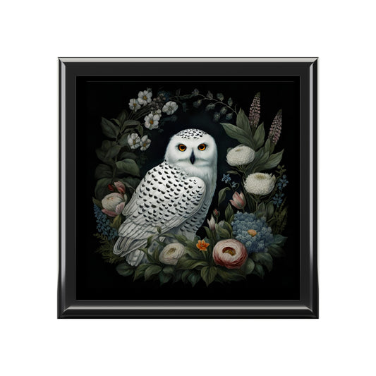 Framed artwork of a snowy owl surrounded by flowers on a black background