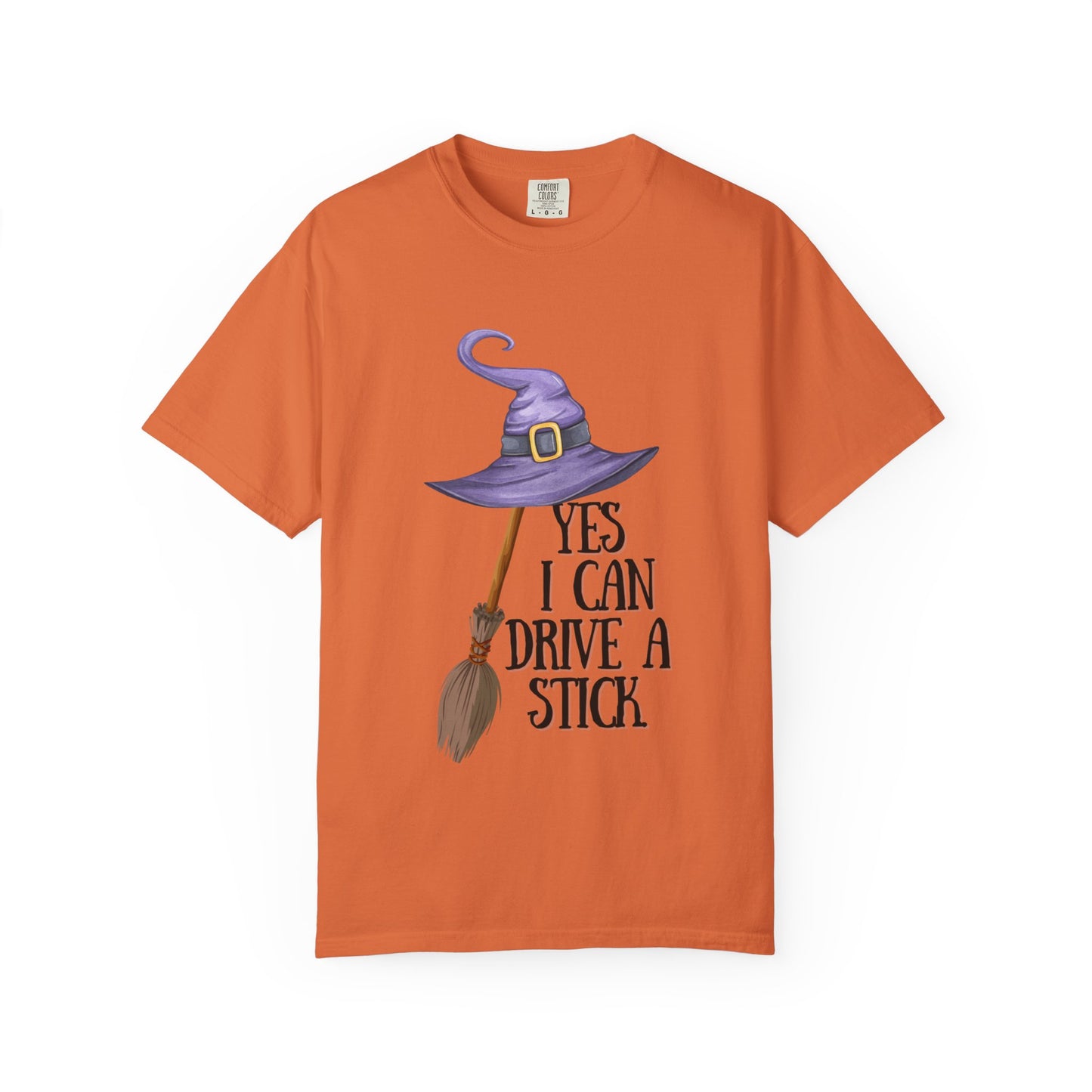 Orange t-shirt with a witch hat and broom graphic and text on a white background