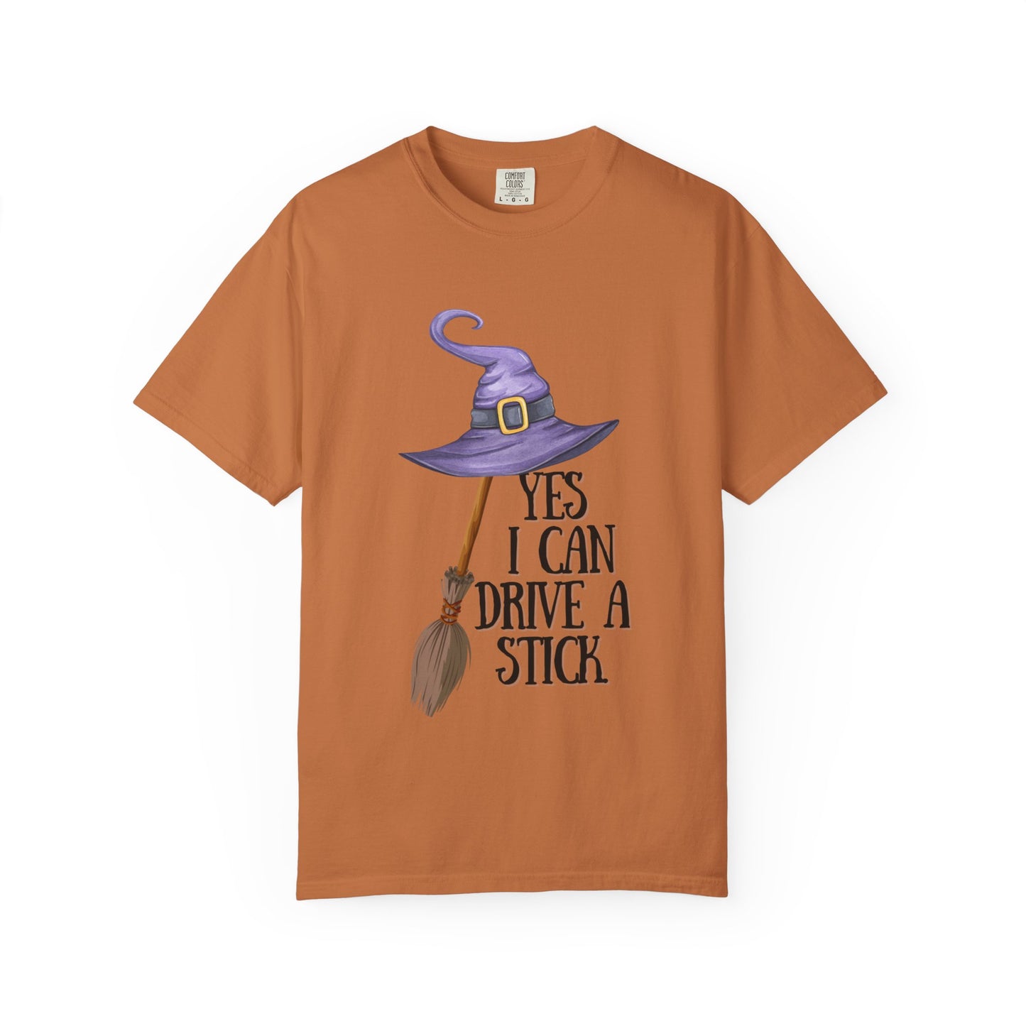 Brown t-shirt with a witch hat and broom graphic and text on a white background