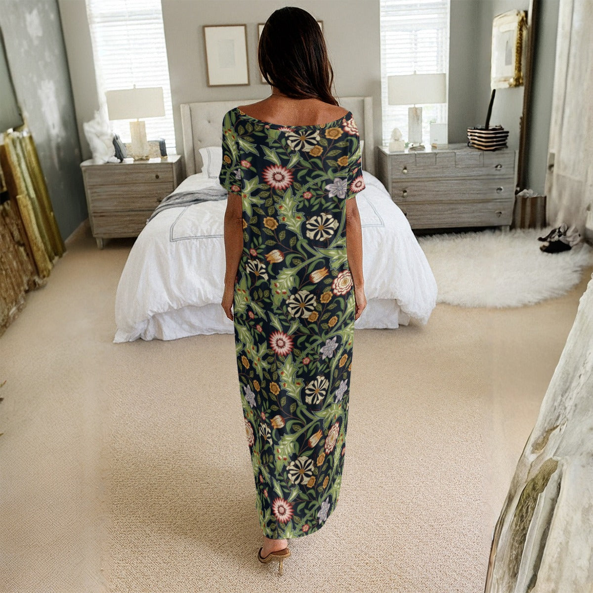 Woman in a floral dress standing in a bedroom