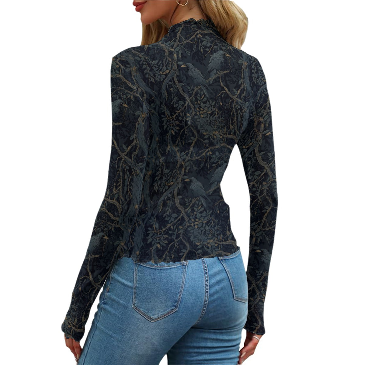 Person wearing a black patterned long-sleeve top and blue jeans on a white background