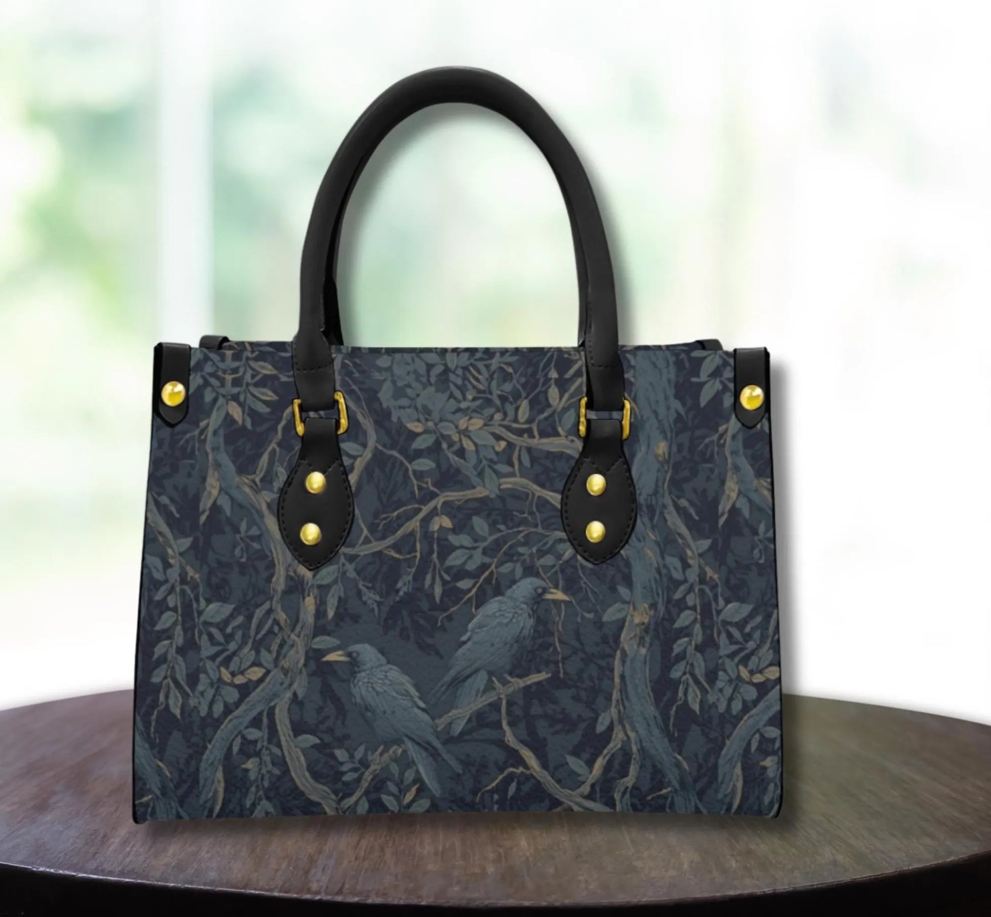 Handbag with bird and branch pattern on a wooden surface