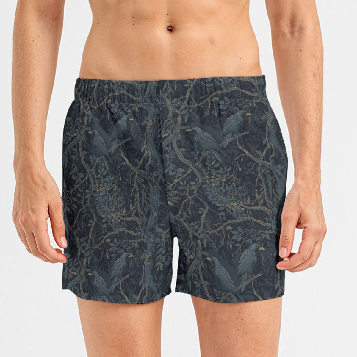 Person wearing dark patterned shorts on a white background