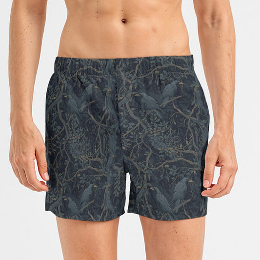 Person wearing dark patterned shorts on a white background