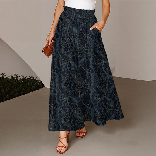 Person wearing a dark blue floral patterned skirt with a white top and brown sandals, holding a small brown bag.