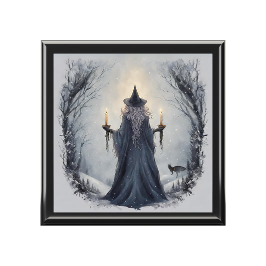 Framed artwork of a wizard in a snowy landscape with candles and a black frame.