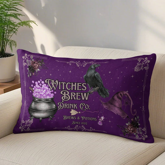 Purple pillow with witch-themed design featuring a pot of purple liquid, a raven, and text on a beige couch.