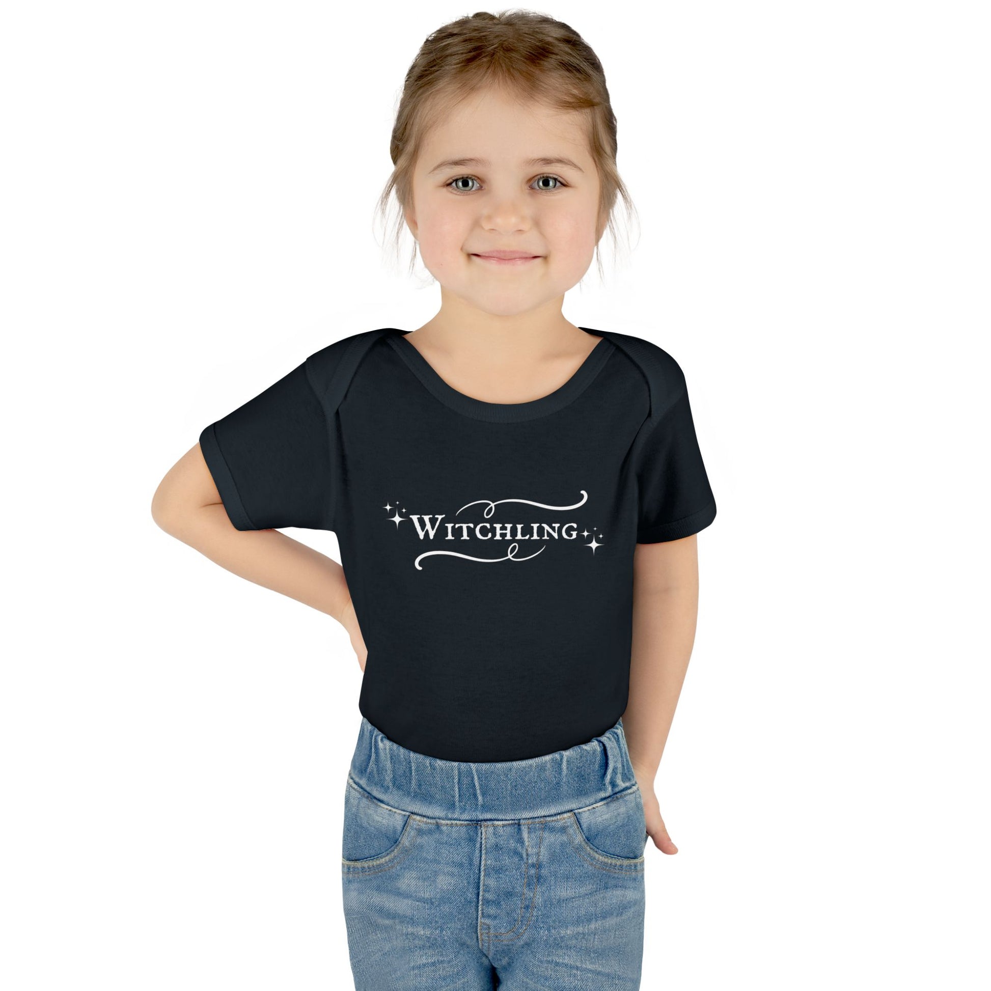 Child wearing a black t-shirt with 'Witchling' text on a white background