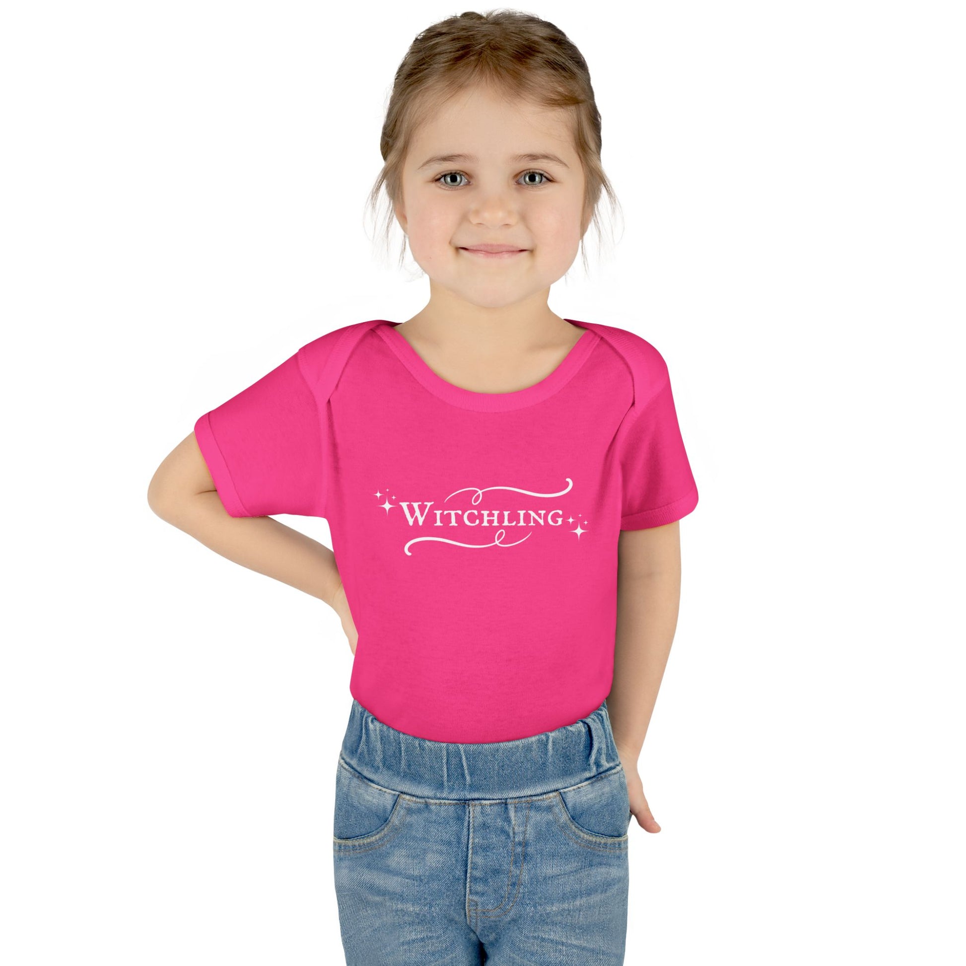 Child wearing a pink t-shirt with 'Witchling' text on a white background