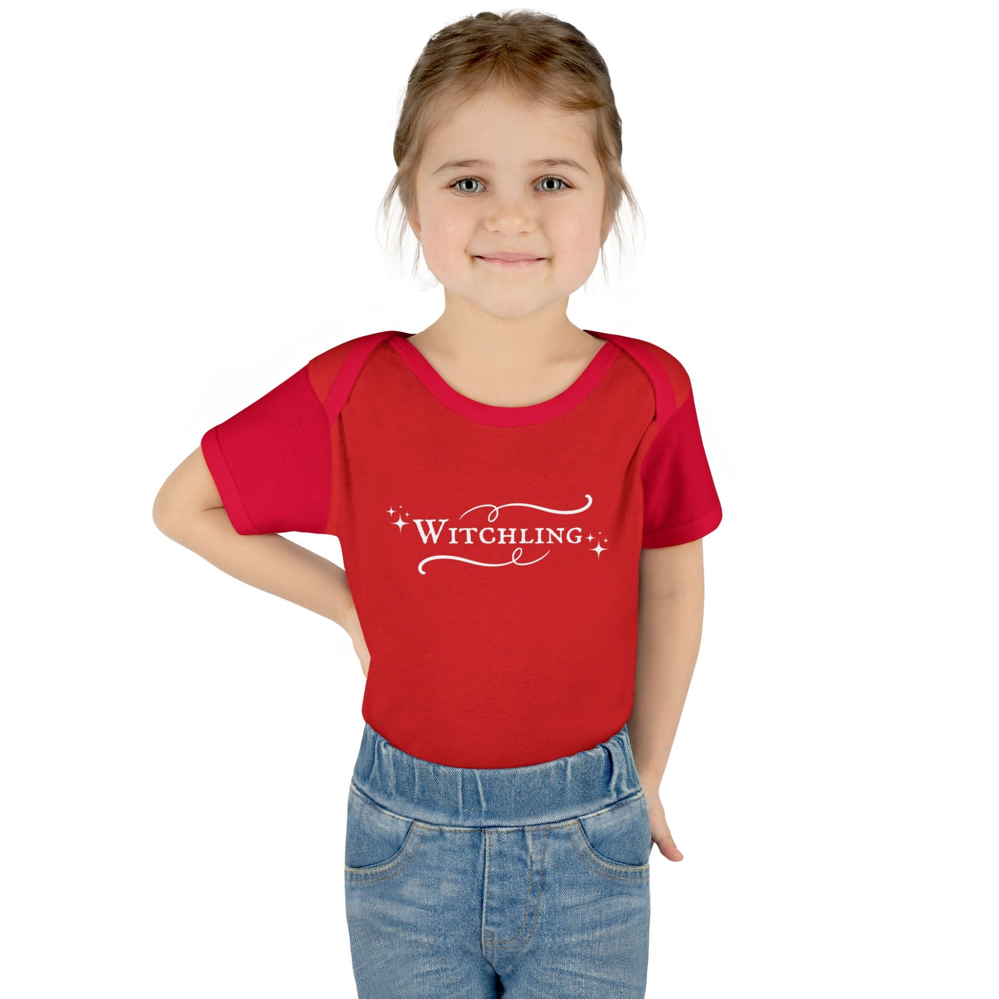 Child wearing a red shirt with 'Witchling' text on a white background