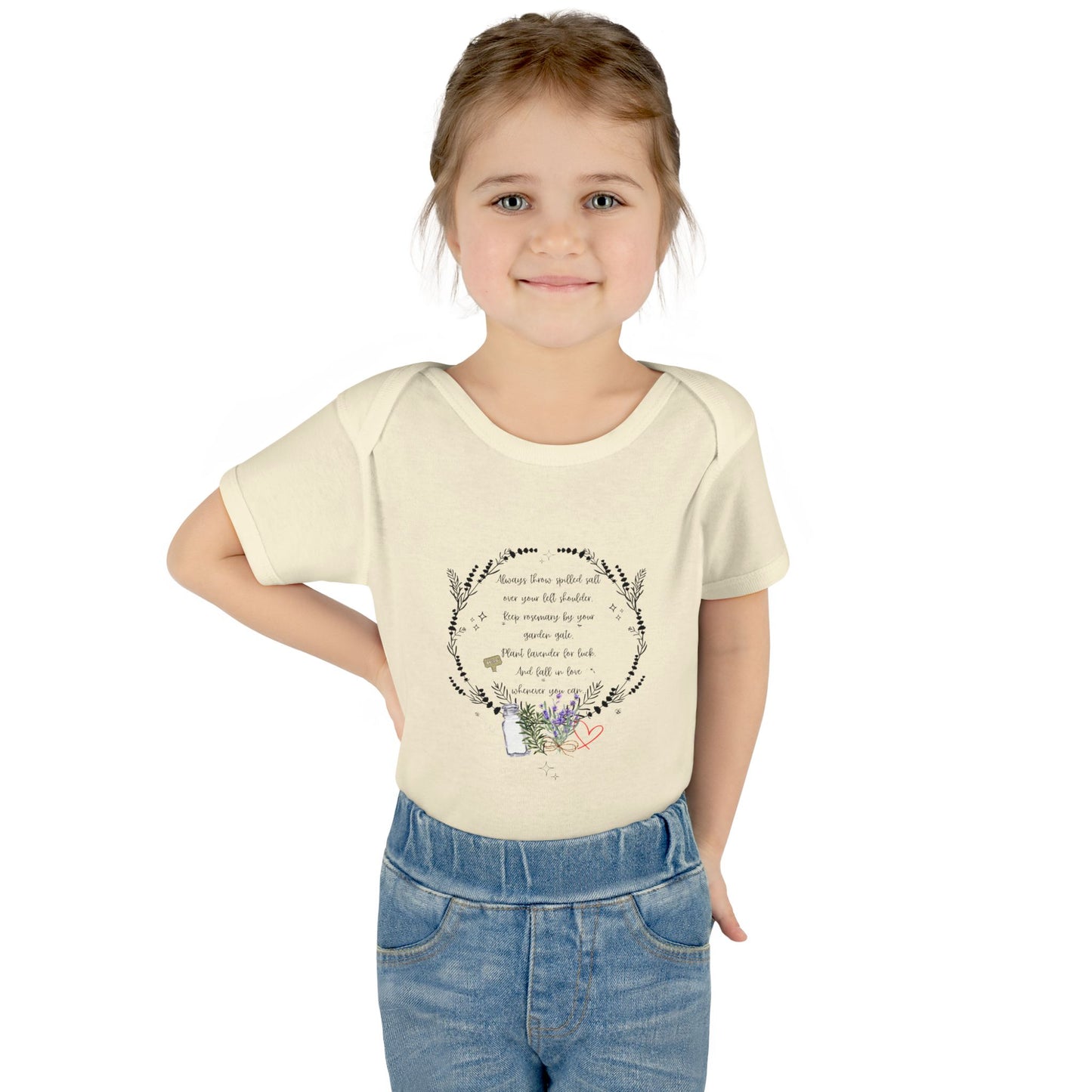 Young girl wearing a cream t-shirt with text and graphics on a white background