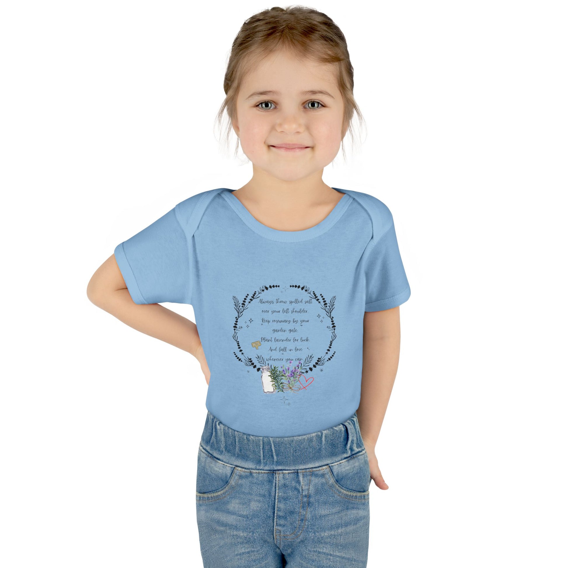 Young girl wearing a blue t-shirt with a design and text on a white background