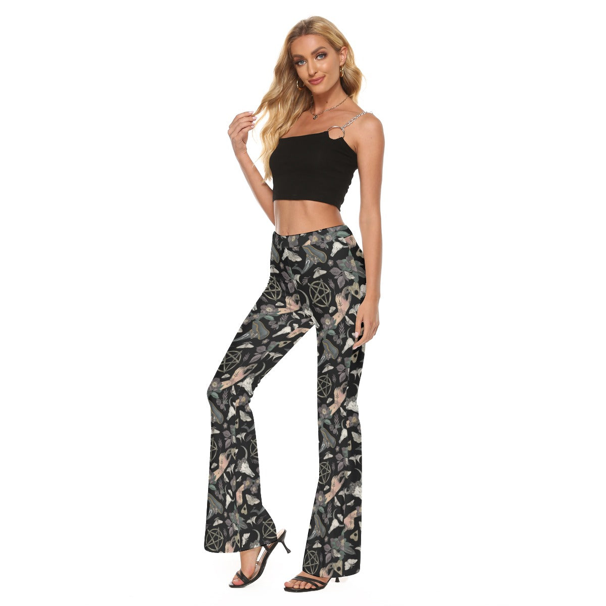 Woman wearing a black crop top and patterned pants on a white background