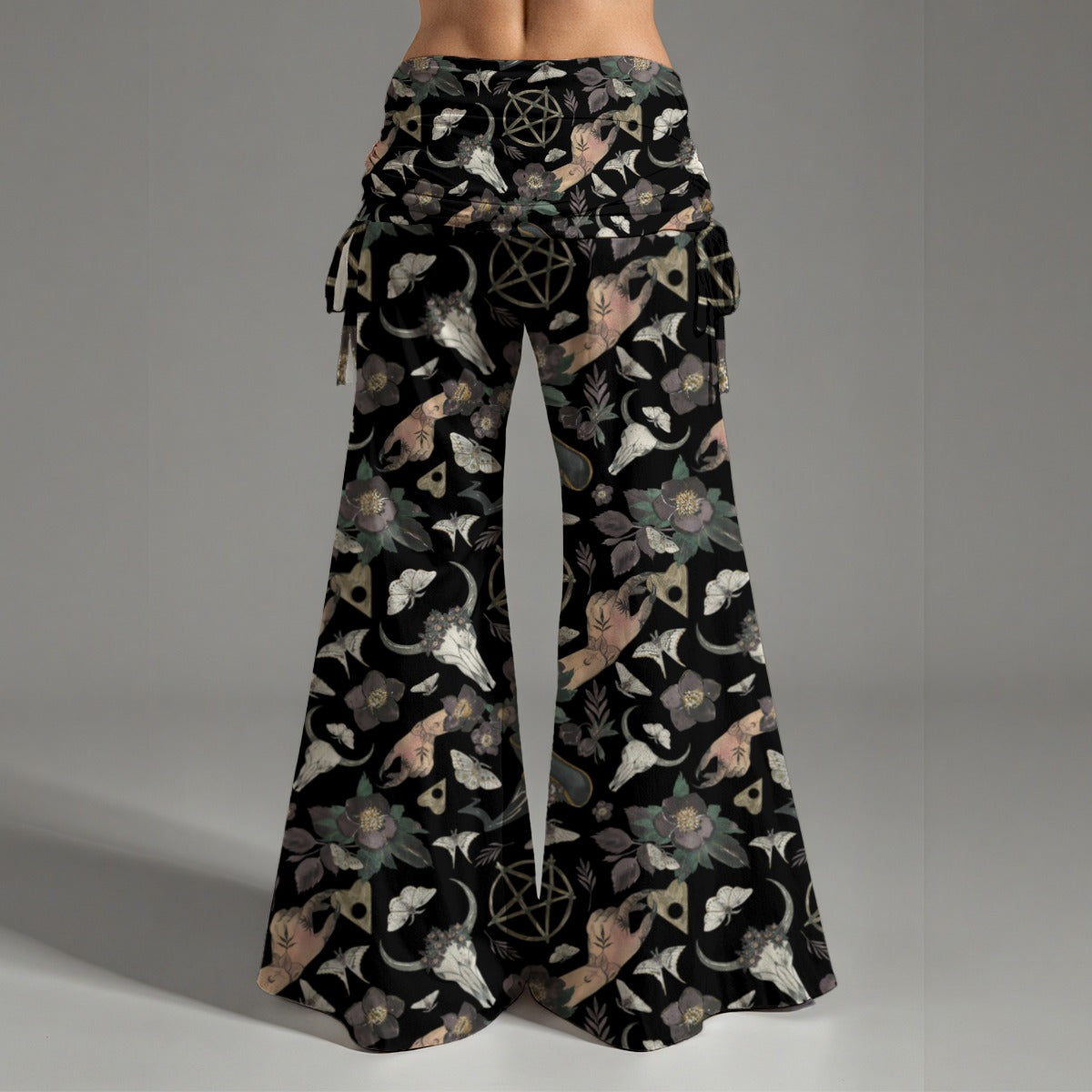 Black wide-leg pants with intricate pattern on a gray background